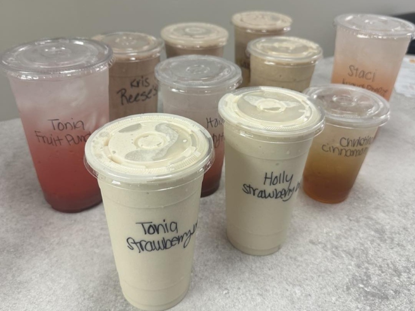 Group of fruit smoothies and teas on a table