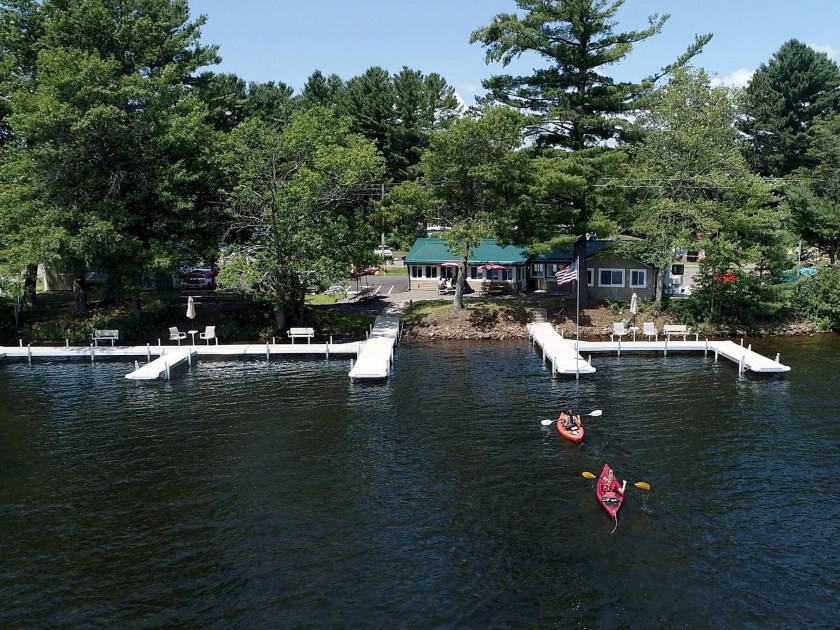 People kayaking near docks on the lake