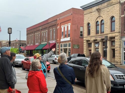 Group of people looking at historic buildings in downtown Chippewa Falls