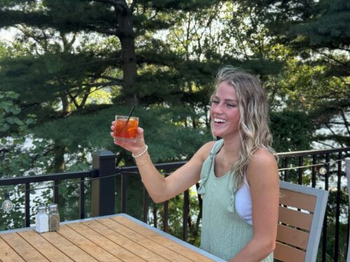 Girl drinking Old Fashioned on outdoor patio