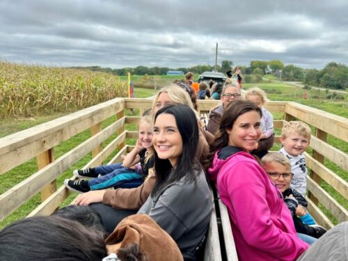 Group riding on wagon ride at an orchard
