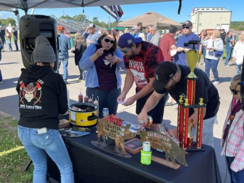people taking samples of bbq sauce 